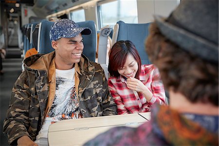simsearch:649-03447280,k - Young couple laughing on passenger train Stock Photo - Premium Royalty-Free, Code: 6113-09131660