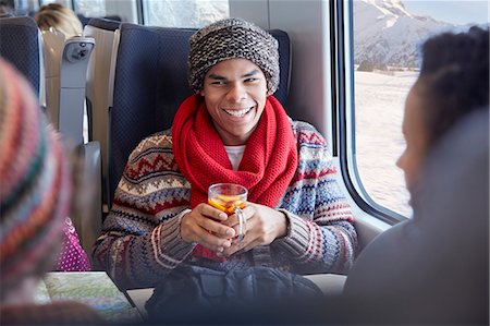 simsearch:6113-09131654,k - Smiling young man drinking mulled wine on passenger train Stockbilder - Premium RF Lizenzfrei, Bildnummer: 6113-09131689