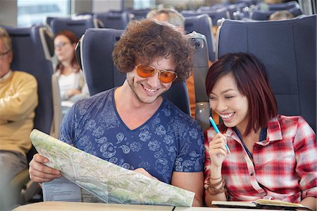 simsearch:6113-09131654,k - Young couple looking at map on passenger train Stockbilder - Premium RF Lizenzfrei, Bildnummer: 6113-09131630