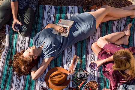 sunning - Overhead view young woman with book relaxing on picnic blanket Stock Photo - Premium Royalty-Free, Code: 6113-09131700