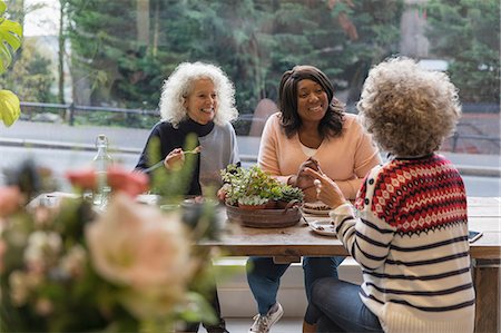 retirement women - Women friends talking and eating lunch at cafe Stock Photo - Premium Royalty-Free, Code: 6113-09131711