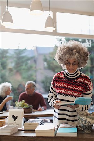 senior coffee shop - Senior woman reading book in shop Stock Photo - Premium Royalty-Free, Code: 6113-09131725