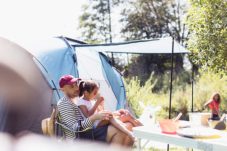 Father and daughter relaxing at campsite Stock Photo - Premium Royalty-Free, Code: 6113-09240002