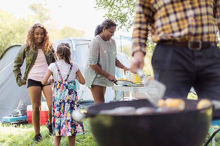 simsearch:6113-09239880,k - Family barbecuing, preparing lunch at campsite Stock Photo - Premium Royalty-Free, Code: 6113-09240010