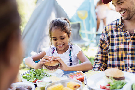 simsearch:6113-09240013,k - Happy father and daughter eating barbecue hamburgers at campsite Stock Photo - Premium Royalty-Free, Code: 6113-09240019