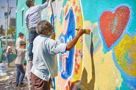 Senior man painting mural on sunny urban wall Stock Photo - Premium Royalty-Free, Code: 6113-09240188