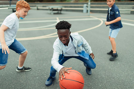 simsearch:632-02690128,k - Tween boys playing basketball in schoolyard Stock Photo - Premium Royalty-Free, Code: 6113-09240303