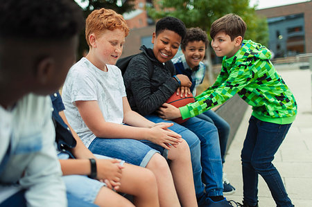 Tween boys with basketball in schoolyard Stock Photo - Premium Royalty-Free, Code: 6113-09240305