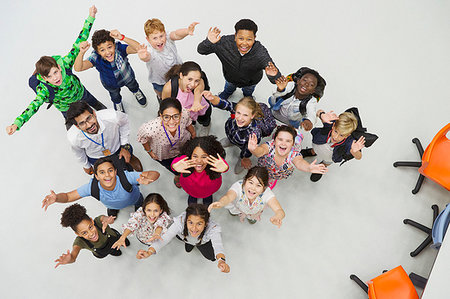 Portrait from above of enthusiastic junior high students and teachers cheering Stock Photo - Premium Royalty-Free, Code: 6113-09240325