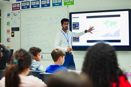 Male teacher at touch screen leading lesson in classroom Stock Photo - Premium Royalty-Free, Code: 6113-09240468