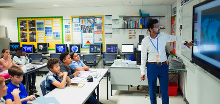 Male teacher leading lesson at touch screen in classroom Stock Photo - Premium Royalty-Free, Code: 6113-09240470