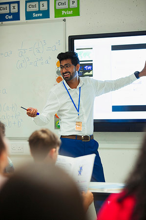 simsearch:649-06533075,k - Smiling male teacher leading lesson in classroom Stock Photo - Premium Royalty-Free, Code: 6113-09240472