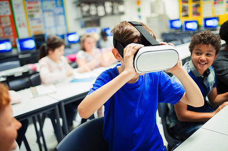 futuristic boy kid - Junior high school boy student using virtual reality simulator glasses in classroom Stock Photo - Premium Royalty-Free, Code: 6113-09240475