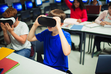 futuristic boy kid - Junior high school boy students using virtual reality simulators in classroom Stock Photo - Premium Royalty-Free, Code: 6113-09240408