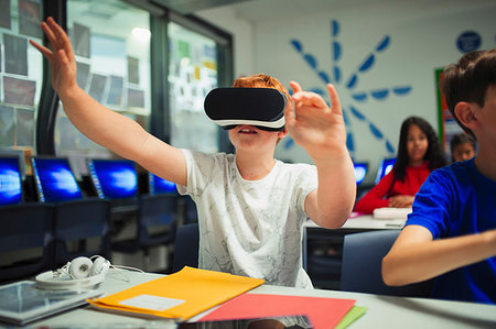 simsearch:632-02690128,k - Curious junior high school boy student using virtual reality simulator in classroom Stock Photo - Premium Royalty-Free, Code: 6113-09240416