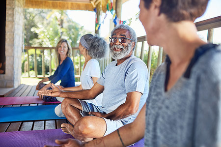 Senior man talking with woman in hut during yoga retreat Stock Photo - Premium Royalty-Free, Code: 6113-09240573