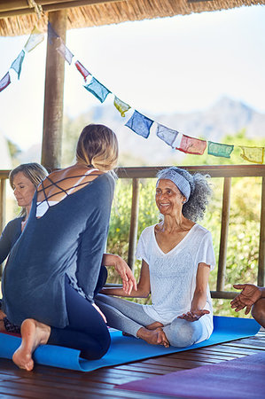 Female instructor talking with student in hut during yoga retreat Stock Photo - Premium Royalty-Free, Code: 6113-09240598