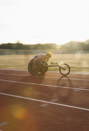 simsearch:6113-09240745,k - Determined young male paraplegic athlete speeding along sports track in wheelchair race Stock Photo - Premium Royalty-Free, Code: 6113-09240616