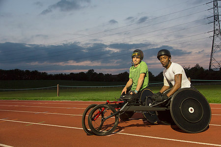 simsearch:6113-09005163,k - Portrait confident paraplegic athletes training for wheelchair race on sports track at night Stock Photo - Premium Royalty-Free, Code: 6113-09240624