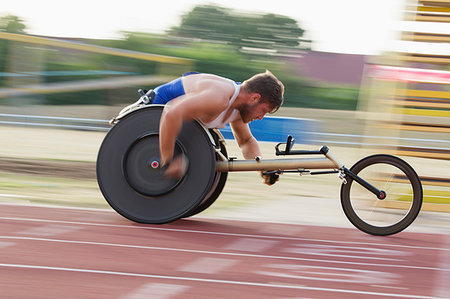 simsearch:6113-09240745,k - Determined young male paraplegic speeding on sports track in wheelchair race Stock Photo - Premium Royalty-Free, Code: 6113-09240717