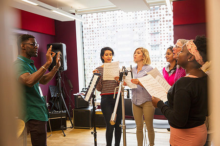 Womens choir with sheet music singing in music recording studio Foto de stock - Sin royalties Premium, Código: 6113-09240883