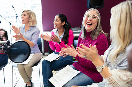 simsearch:6113-09168289,k - Happy womens choir with sheet music singing in music recording studio Stock Photo - Premium Royalty-Free, Code: 6113-09240887