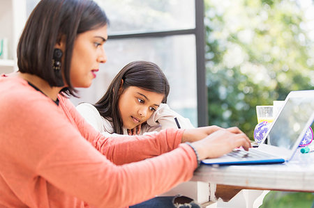 simsearch:6113-08784443,k - Mother and daughter using laptop, doing homework at table Stock Photo - Premium Royalty-Free, Code: 6113-09241070