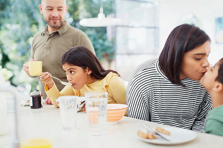 family eating cereal - Affectionate family enjoying breakfast Stock Photo - Premium Royalty-Free, Code: 6113-09241009