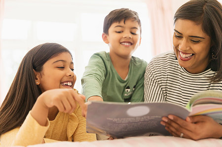 parents reading bedtime story - Mother and children reading book Stock Photo - Premium Royalty-Free, Code: 6113-09241017