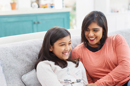 simsearch:693-03363809,k - Happy mother and daughter on sofa Stock Photo - Premium Royalty-Free, Code: 6113-09241103