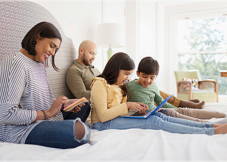 father son bedroom - Family using technology on bed Stock Photo - Premium Royalty-Free, Code: 6113-09241104