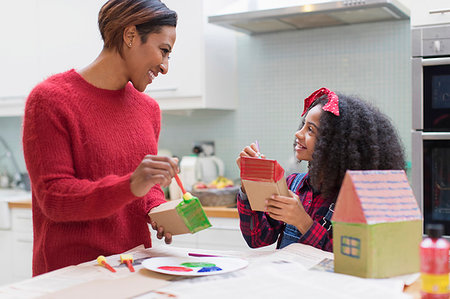 simsearch:6108-06167232,k - Mother and daughter painting house crafts in kitchen Stock Photo - Premium Royalty-Free, Code: 6113-09241323