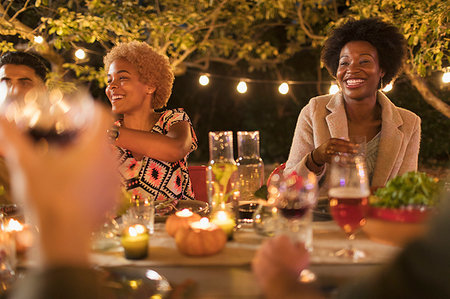 simsearch:6113-09241347,k - Happy friends enjoying dinner garden party Stock Photo - Premium Royalty-Free, Code: 6113-09241423