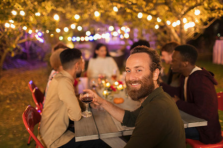 simsearch:6113-09241347,k - Portrait confident man drinking wine, enjoying dinner garden party Stock Photo - Premium Royalty-Free, Code: 6113-09241437