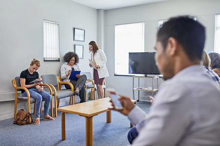 simsearch:6113-08521480,k - Doctor and patients in clinic waiting room Stock Photo - Premium Royalty-Free, Code: 6113-09241570