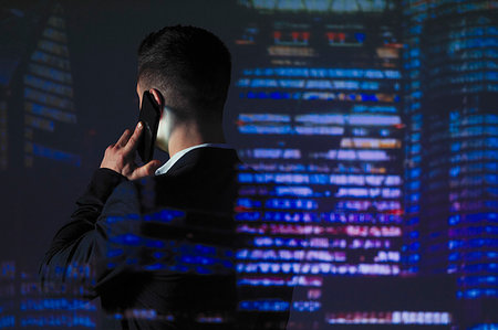 smartphone city night - Double exposure businessman talking on smart phone against highrise lights at night Stock Photo - Premium Royalty-Free, Code: 6113-09272418