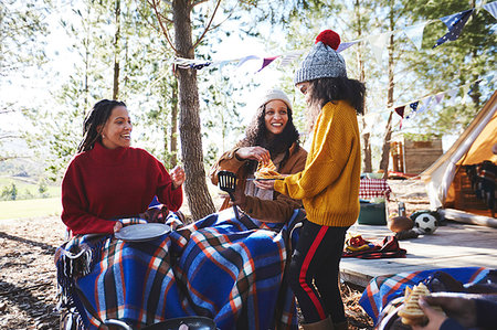 Happy lesbian couple and daughter enjoying breakfast at sunny campsite in woods Stock Photo - Premium Royalty-Free, Code: 6113-09272770