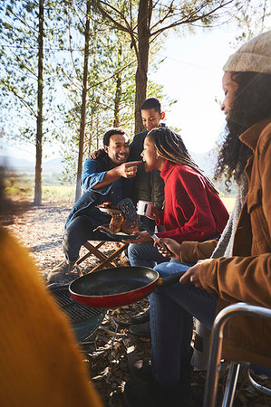 fall campfire - Husband feeding wife at campsite Stock Photo - Premium Royalty-Free, Code: 6113-09272774