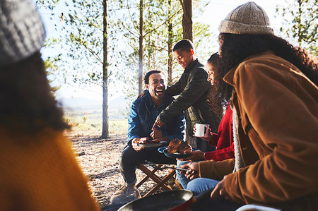 simsearch:6113-09272797,k - Happy family eating at sunny campsite Fotografie stock - Premium Royalty-Free, Codice: 6113-09272846