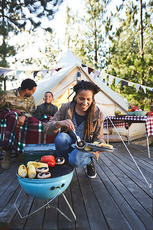 simsearch:6113-09272797,k - Smiling woman cooking vegetables on campsite grill Fotografie stock - Premium Royalty-Free, Codice: 6113-09272824