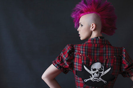 Confident, cool young woman with pink mohawk Stock Photo - Premium Royalty-Free, Code: 6113-09200064