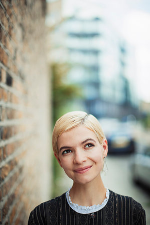 simsearch:6113-07565565,k - Portrait confident, curious young woman on urban sidewalk Stock Photo - Premium Royalty-Free, Code: 6113-09220573