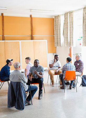 Men talking in group therapy in community center Stock Photo - Premium Royalty-Free, Code: 6113-09220757