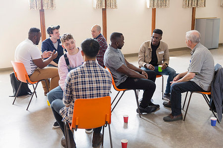 Men talking in group therapy in community center Stock Photo - Premium Royalty-Free, Code: 6113-09220760