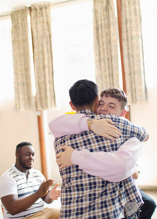 simsearch:6113-09220733,k - Men hugging in group therapy Stock Photo - Premium Royalty-Free, Code: 6113-09220764