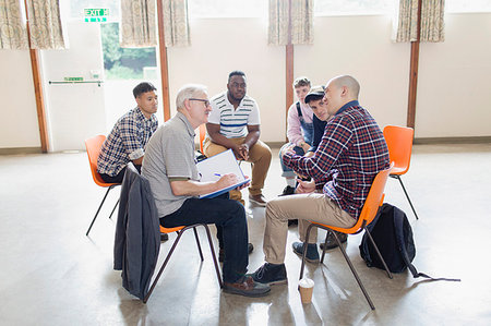 Men talking in circle in group therapy Stock Photo - Premium Royalty-Free, Code: 6113-09220768