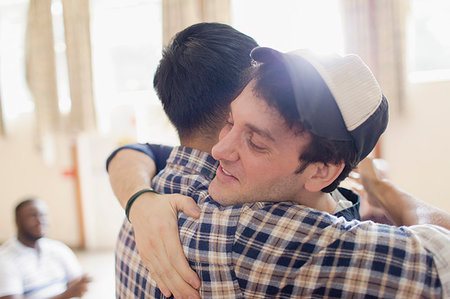 Men hugging Stock Photo - Premium Royalty-Free, Code: 6113-09220773