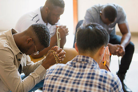 photo of boy sitting with his head down - Men praying with rosaries in prayer group Stock Photo - Premium Royalty-Free, Code: 6113-09220731