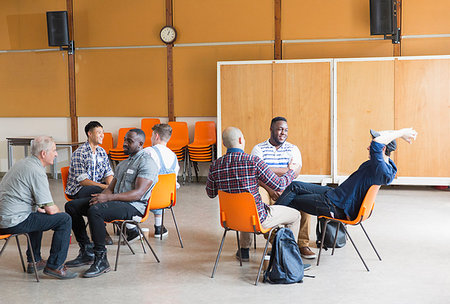 Men talking in group therapy in community center Stock Photo - Premium Royalty-Free, Code: 6113-09220739