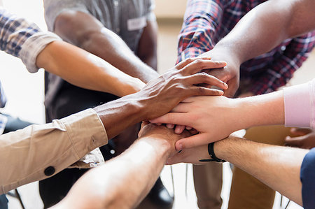 Men joining hands in huddle Stock Photo - Premium Royalty-Free, Code: 6113-09220816